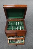 An Edwardian oak lift top cutlery chest of four drawers containing a quantity of assorted plated