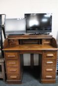 An Edwardian oak roll top desk