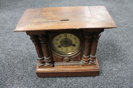 An Edwardian pine cased mantel clock with brass and enamelled dial