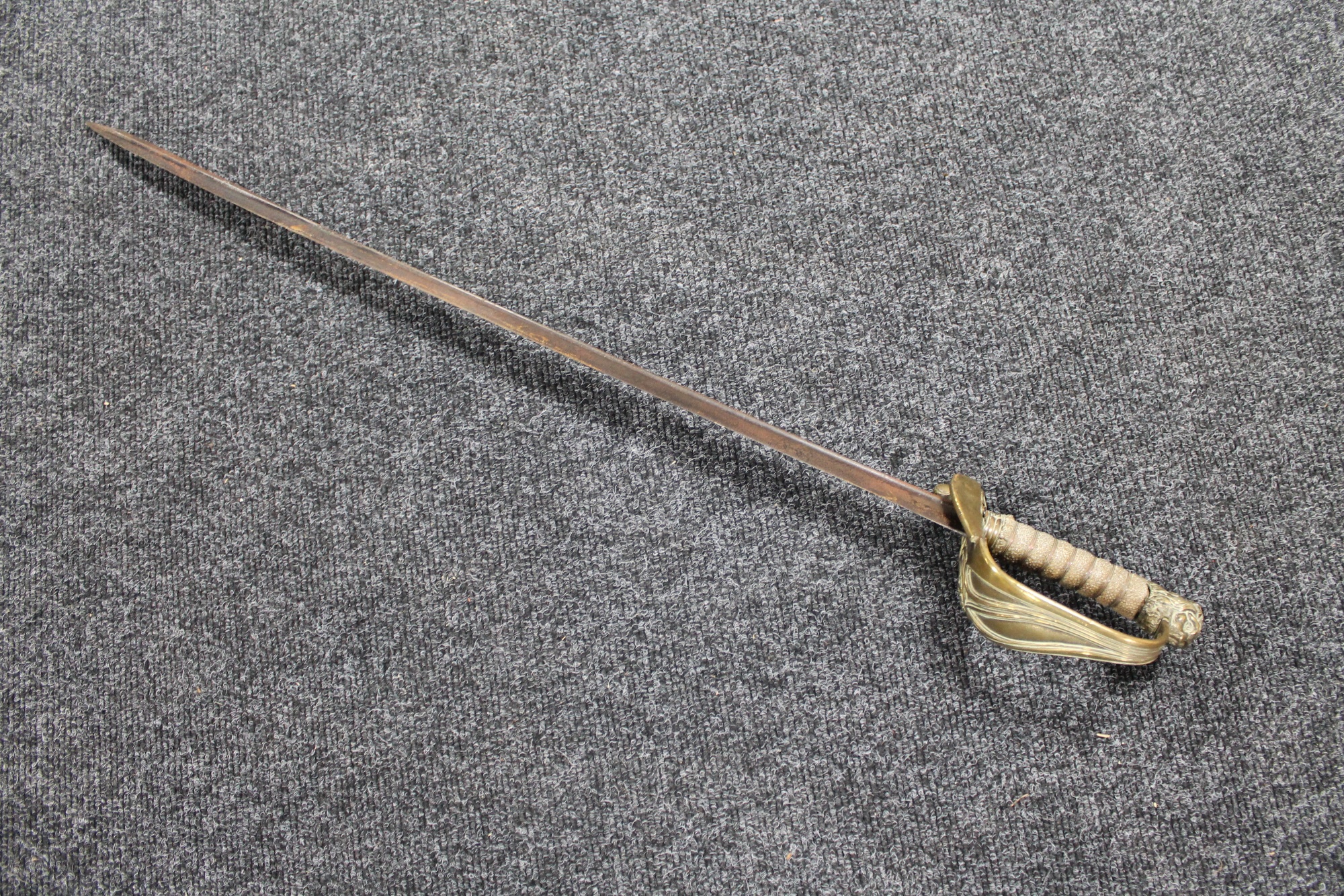 A 19th century brass handled sword with lion head pommel