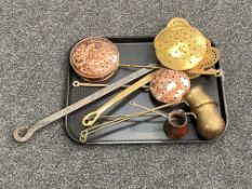 A tray of four antique copper and brass chestnut roasters and three drinks measures