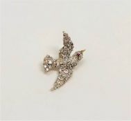 A superb quality antique diamond set swallow brooch with ruby eye,