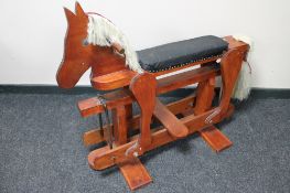 A mid 20th century stained pine rocking horse