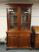 A Victorian style glazed mahogany bookcase with ebonised pillars, width 120 cm,