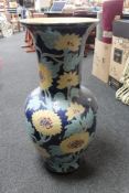 A floor standing floral glazed pottery vase