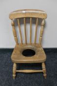 An antique pine child's commode chair