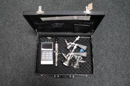 A leather brief case containing Kegmiser electronic meter,