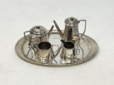 A four piece miniature silver tea set on silver tray (5),