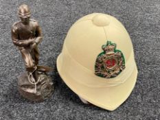 A resin figure of a Zulu War soldier and replica helmet