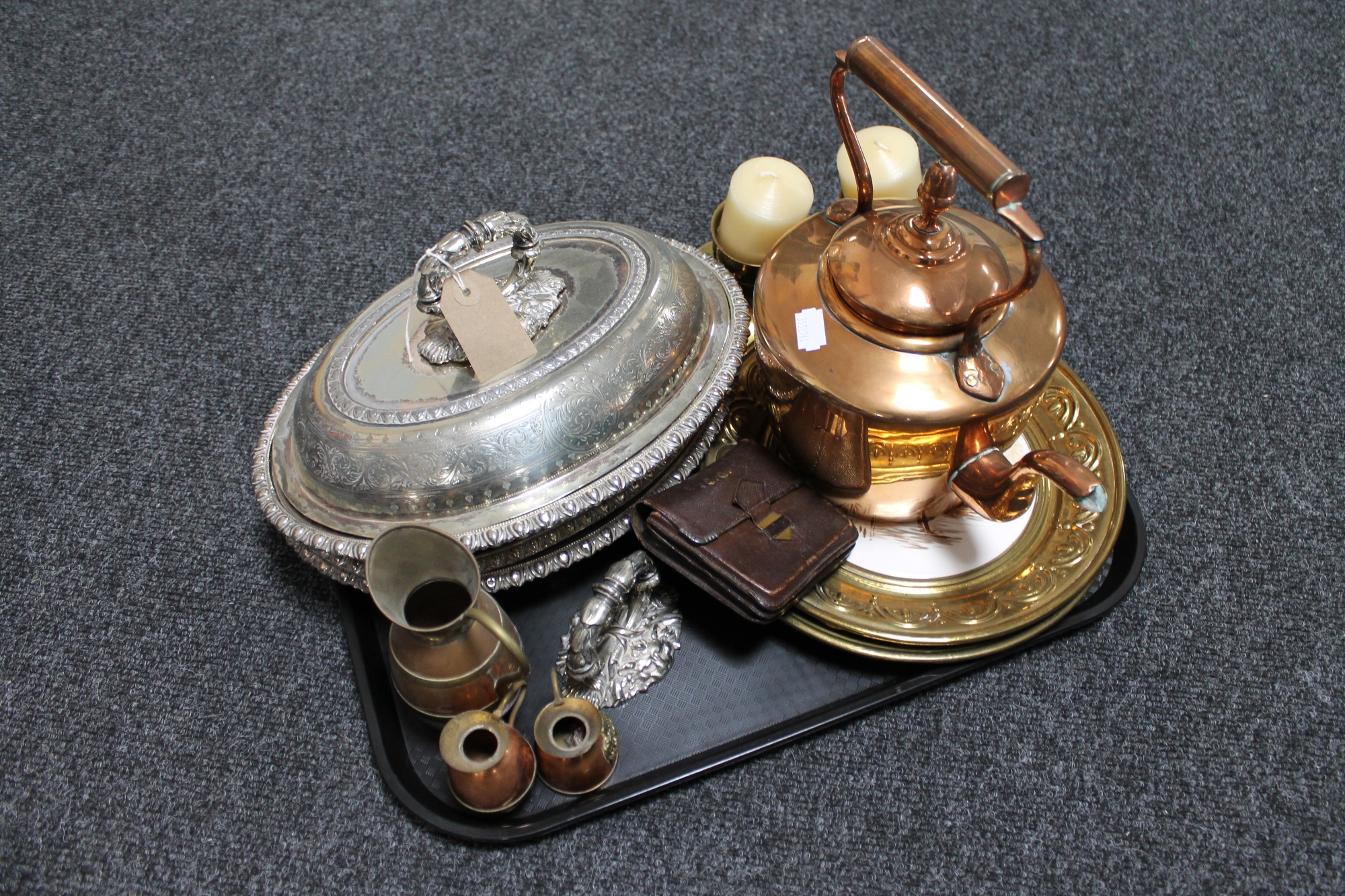 A tray of antique coper kettle, two antique plated entree dishes, brass candlesticks,