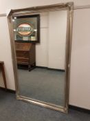 A silvered swept framed mirror 167 cm x 105 cm