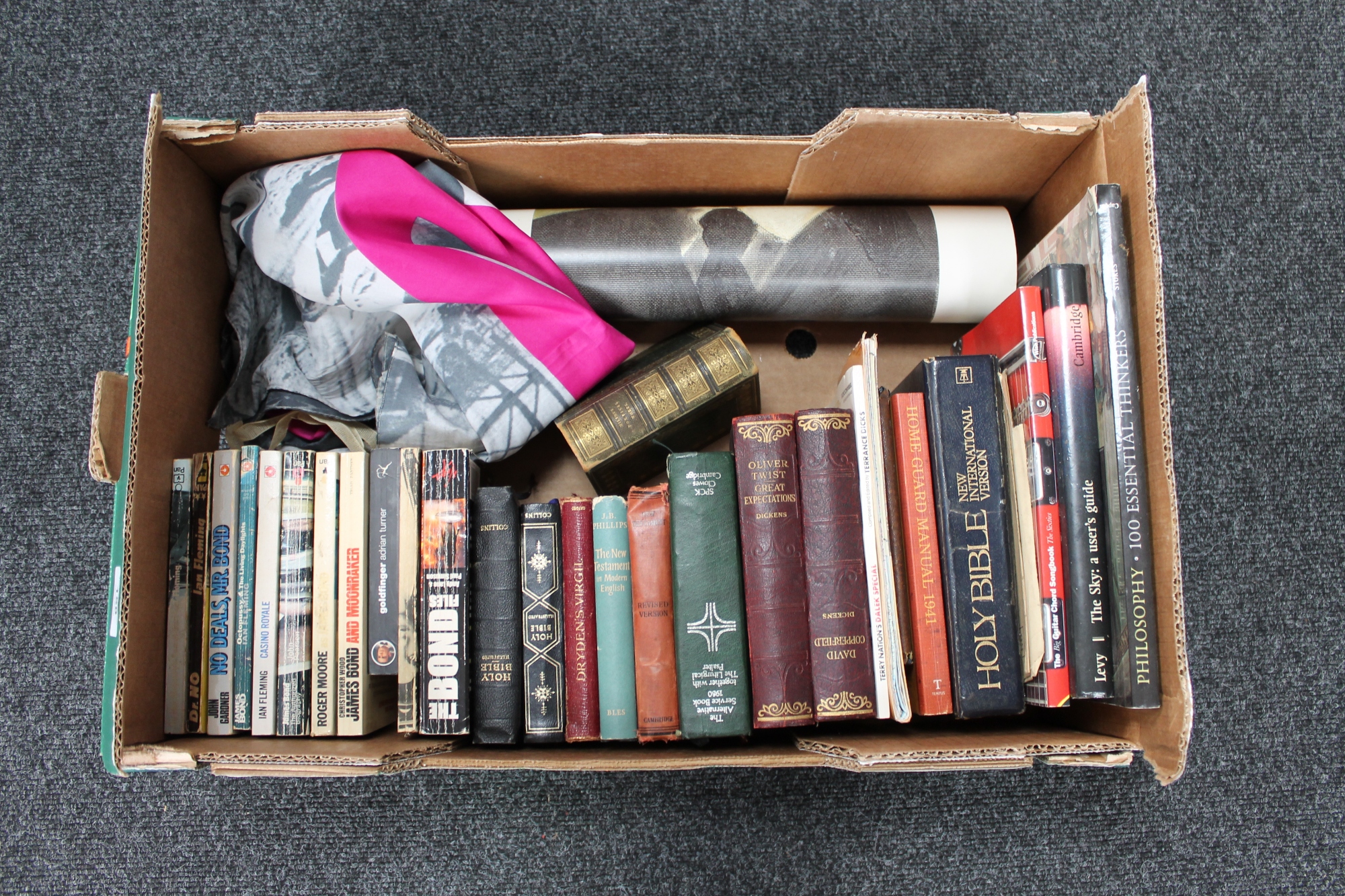 A box of assorted books to include eleven paperback James Bond books, Dickens,