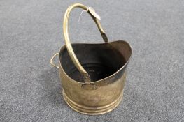 An antique brass coal bucket