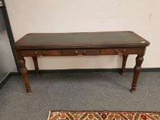 A Victorian mahogany three drawer library table with green leather top,