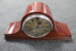 An antique mahogany Westminster chime mantel clock with silvered dial on raised feet