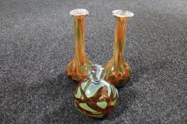 A Mdina glass paperweight and two studio glass vases with flared rims