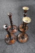 Two pairs of antique oak barley twist candlesticks,