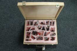 A wooden carry case containing twenty-three hand-painted metal soldier figures relating in the main