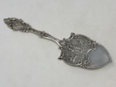 An ornate silver cake slice,