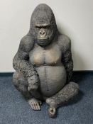 A life size resin figure of a seated gorilla