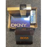A box of four assorted men's after shaves and gift sets including Hugo Boss, Calvin Klein,