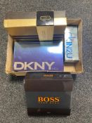 A box of four assorted men's after shaves and gift sets including Hugo Boss, Calvin Klein,