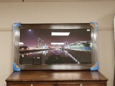 A framed print of a bridge scene,