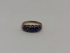 A 9ct gold synthetic sapphire five stone ring, size L CONDITION REPORT: 1.