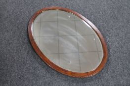 An early 20th century oval framed bevelled mirror