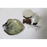 A Chinese jade carved disc on stand together with a further carved piece of jade on stand,