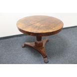 A Regency rosewood circular pedestal table on paw feet