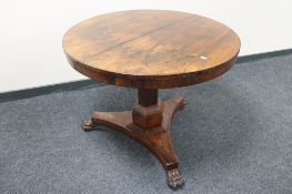 A Regency rosewood circular pedestal table on paw feet