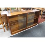 A set of mid century teak sliding glass door bookshelves