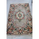 A fringed Chinese floral embossed rug