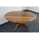 An oval Victorian breakfast table on three way carved cabriole leg pedestal