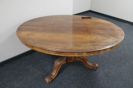 An oval Victorian breakfast table on three way carved cabriole leg pedestal