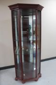 A mahogany effect corner display cabinet