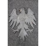 A Prussian style cast lead eagle plaque/coat of arms bearing three crowns