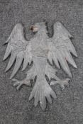 A Prussian style cast lead eagle plaque/coat of arms bearing three crowns