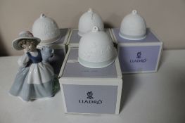 Four boxed Lladro bells together with a Nao figure of a girl