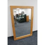 A contemporary oak overmantel mirror