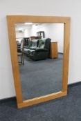 A contemporary oak overmantel mirror