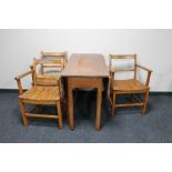 A drop leaf kitchen table and three armchairs