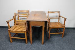A drop leaf kitchen table and three armchairs