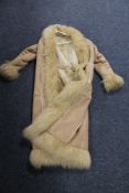 A lady's full length sheep skin coat with faux fur lining