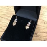 A pair of three tone 10ct gold earrings
