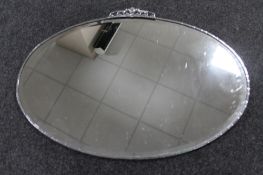 A 1930's oval chrome framed bevelled mirror