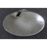 A 1930's oval chrome framed bevelled mirror