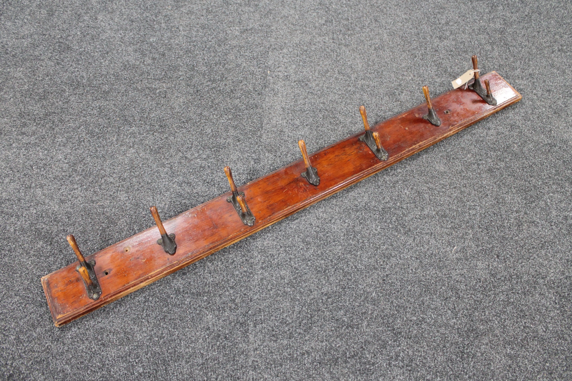 An early 20th century seven hook coat rack