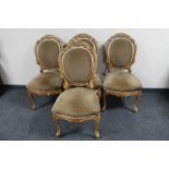 A set of four carved French walnut dining chairs